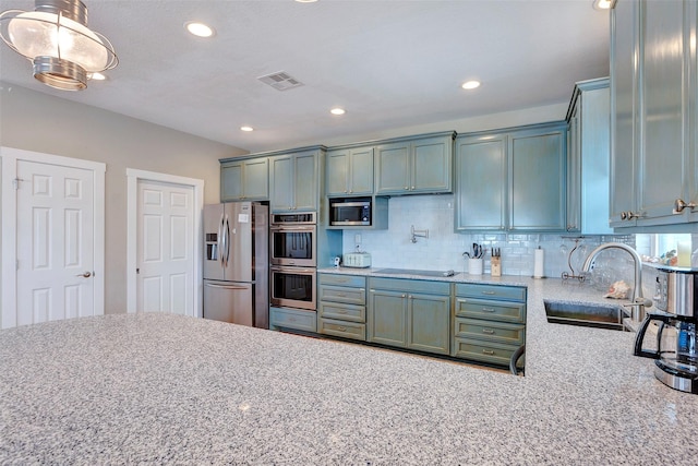 126 Driftwood, Freeport, TX 77541 - kitchen with stainless steel appliances, a sink, tasteful backsplash, recessed lighting, and light stone counters