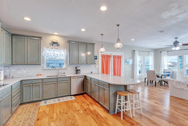 126 Driftwood, Freeport, TX 77541 - kitchen with stainless steel dishwasher, a sink, a peninsula, plenty of natural light, and recessed lighting