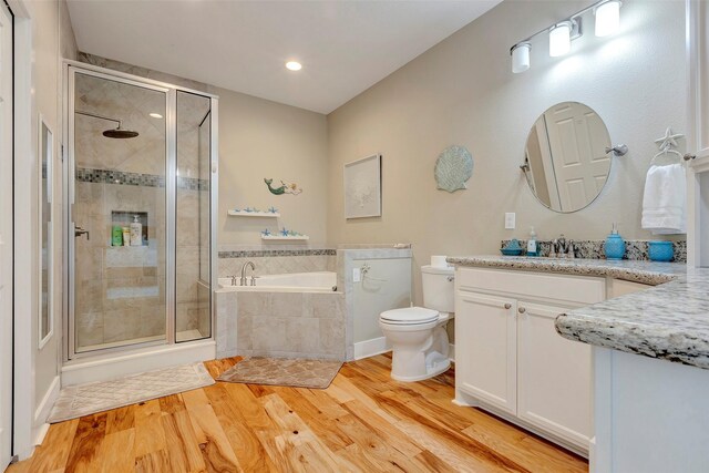 126 Driftwood, Freeport, TX 77541 - bathroom with a stall shower, a garden tub, wood finished floors, vanity, and recessed lighting