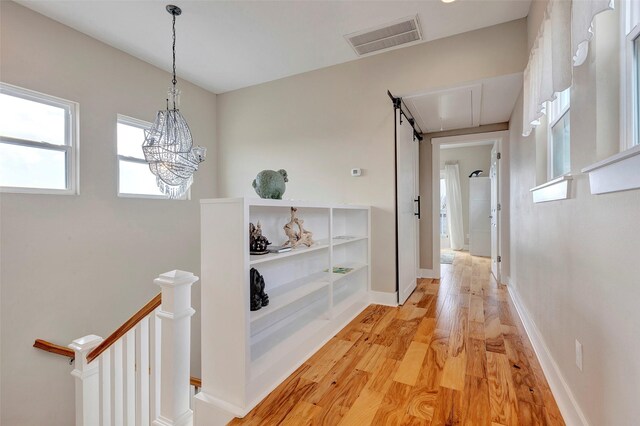 126 Driftwood, Freeport, TX 77541 - corridor featuring an upstairs landing, light wood-style floors, baseboards, and a chandelier