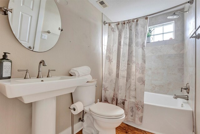 126 Driftwood, Freeport, TX 77541 - bathroom with toilet, shower / tub combo, and wood finished floors