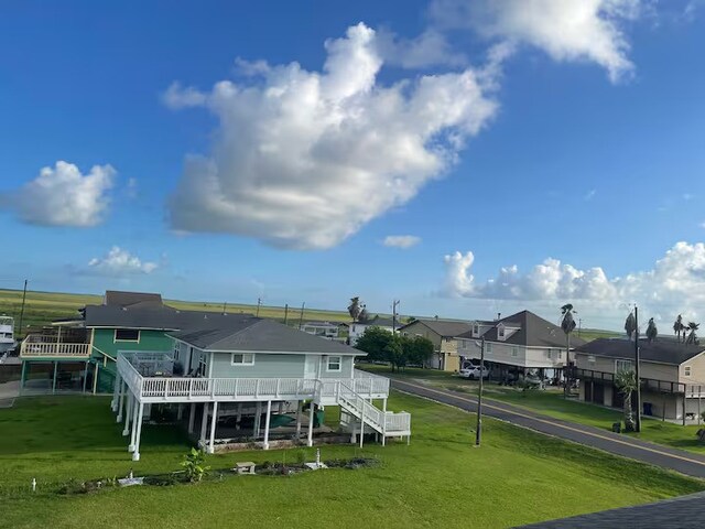 126 Driftwood, Freeport, TX 77541 - back of house with a residential view, a yard, a deck, and stairway