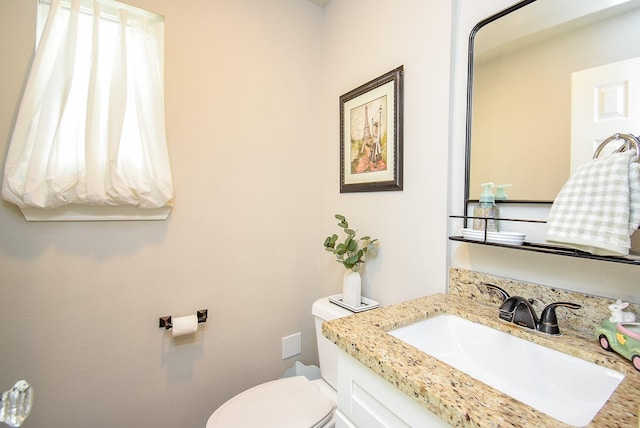 bathroom featuring toilet and vanity