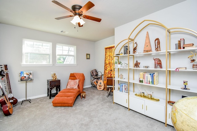 sitting room featuring ceiling fan, baseboards, visible vents, and carpet