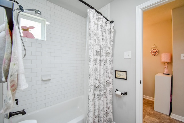 bathroom with shower / bath combo, baseboards, and tile patterned flooring