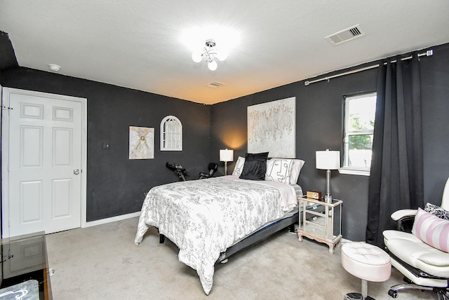 carpeted bedroom featuring baseboards and visible vents