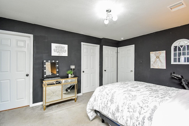 carpeted bedroom with baseboards and visible vents