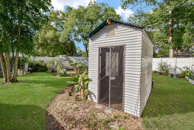 view of outbuilding featuring a fenced backyard and an outdoor structure