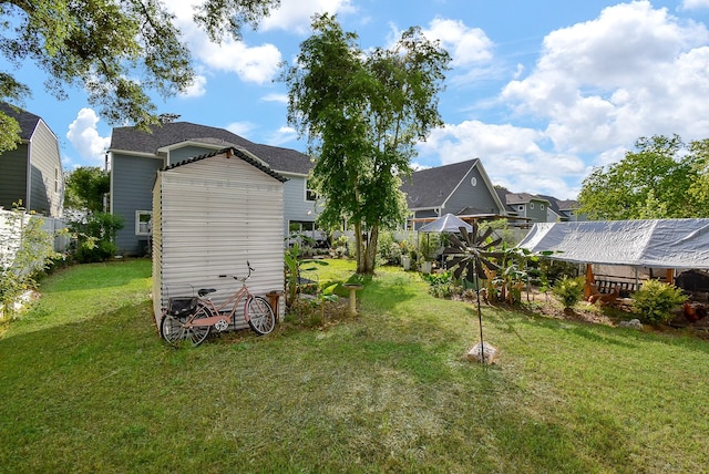 view of yard with an outbuilding and a shed