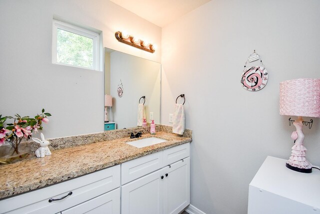 bathroom with baseboards and vanity