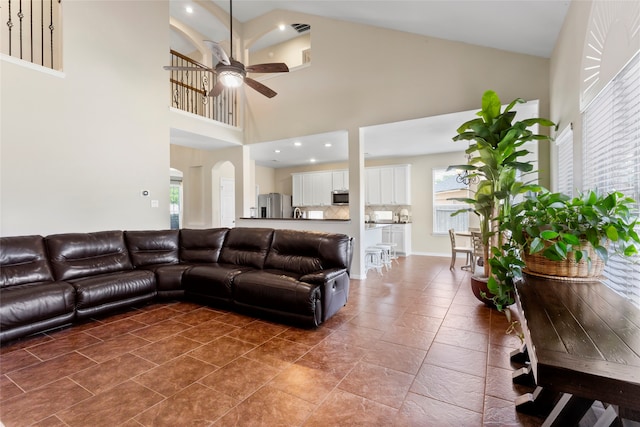 7410 Norwood Point Ct, Richmond, TX 77407 - living area featuring ceiling fan, healthy amount of natural light, arched walkways, and high vaulted ceiling