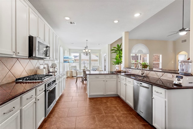 7410 Norwood Point Ct, Richmond, TX 77407 - kitchen featuring a sink, appliances with stainless steel finishes, dark countertops, backsplash, and recessed lighting