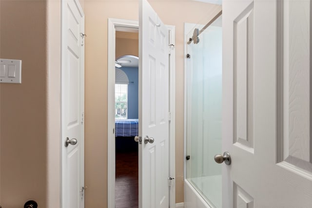 7410 Norwood Point Ct, Richmond, TX 77407 - ensuite bathroom featuring washtub / shower combination and wood finished floors