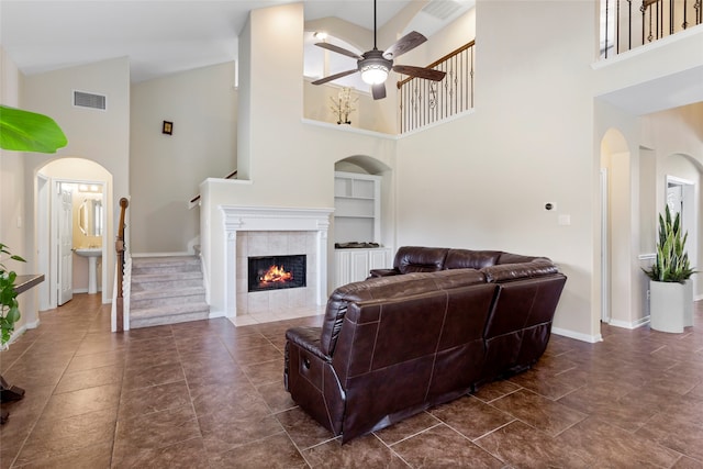 7410 Norwood Point Ct, Richmond, TX 77407 - living room featuring a ceiling fan, high vaulted ceiling, built in features, baseboards, and a fireplace