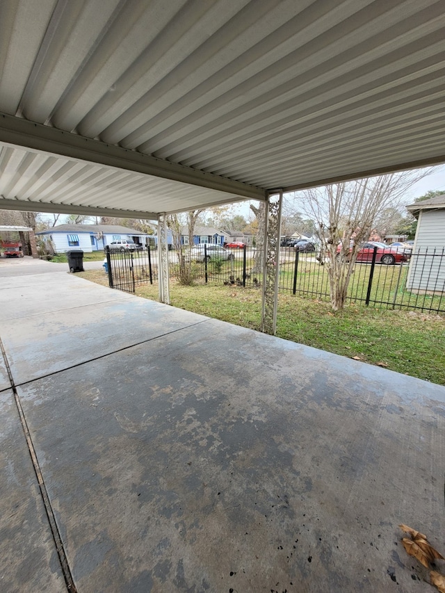 view of patio / terrace featuring fence and a carport