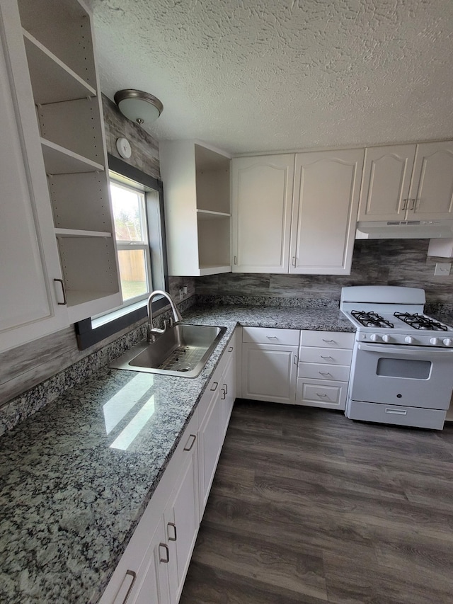 kitchen with white cabinets, white gas range oven, a sink, open shelves, and under cabinet range hood