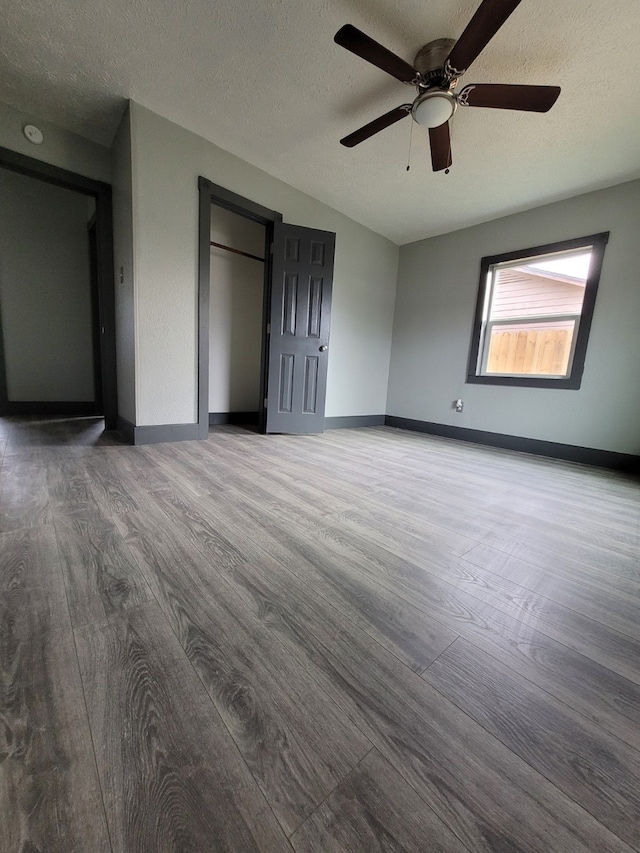unfurnished bedroom featuring wood finished floors and a textured ceiling
