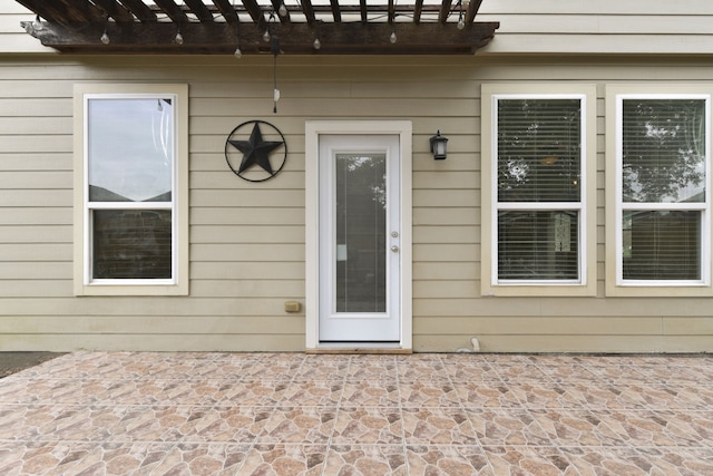 2830 Meadowbrook Ln, Rosenberg, TX 77471 - view of exterior entry with a pergola and a patio area