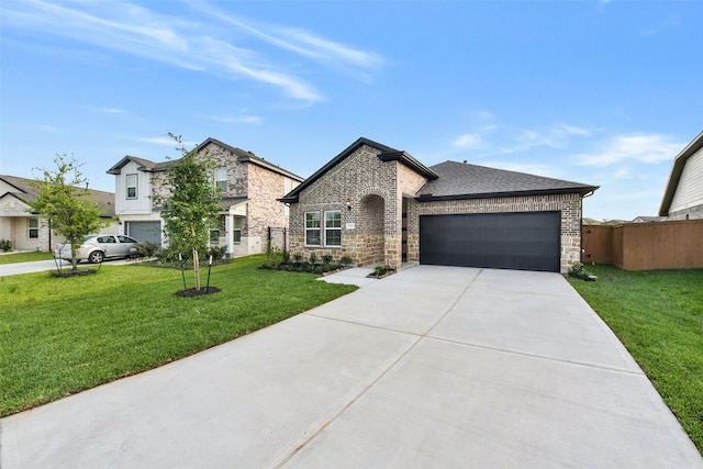 french country inspired facade featuring fence, a front lawn, brick siding, a garage, and concrete driveway