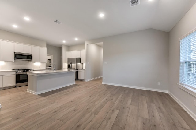 kitchen with recessed lighting, appliances with stainless steel finishes, visible vents, and light wood-type flooring