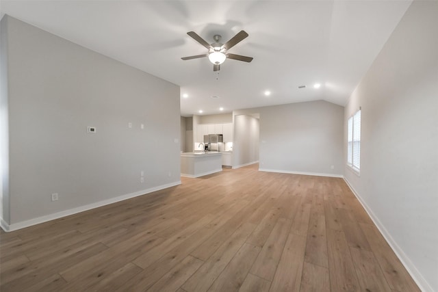 unfurnished living room featuring light wood-type flooring, a ceiling fan, baseboards, and recessed lighting
