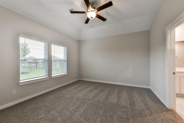 carpeted spare room with baseboards, visible vents, a ceiling fan, and lofted ceiling