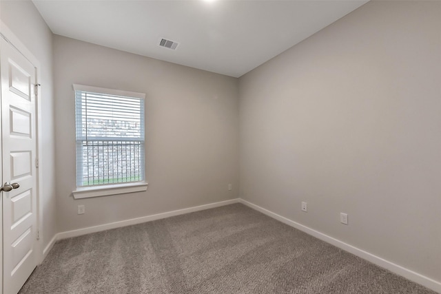carpeted empty room with baseboards and visible vents