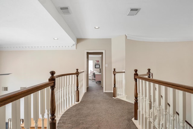 hall with visible vents, an upstairs landing, carpet flooring, and recessed lighting