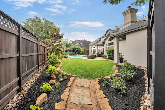 view of yard featuring a fenced backyard, a fenced in pool, and a patio area