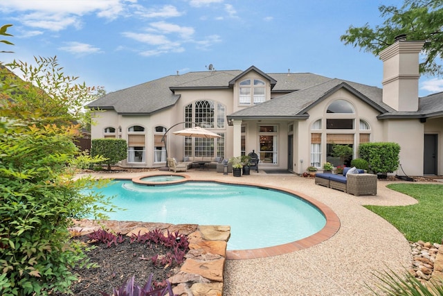 back of property with a chimney, an outdoor living space, stucco siding, a shingled roof, and a patio area