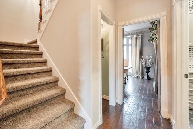 stairway featuring hardwood / wood-style floors and baseboards