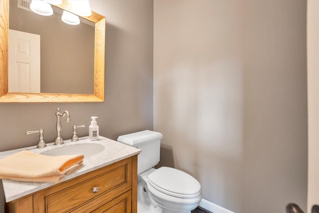 bathroom featuring toilet and vanity