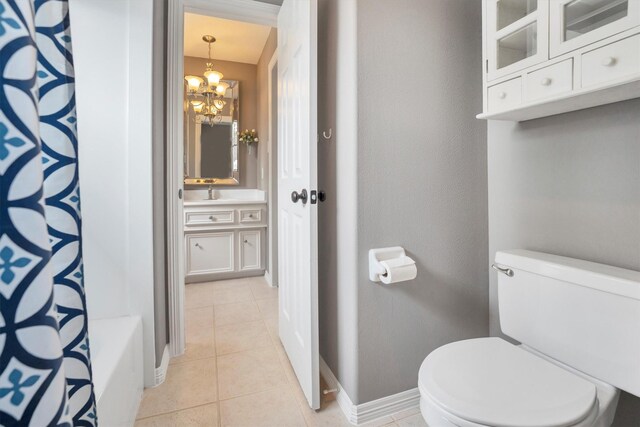 full bathroom with curtained shower, baseboards, toilet, a notable chandelier, and tile patterned flooring