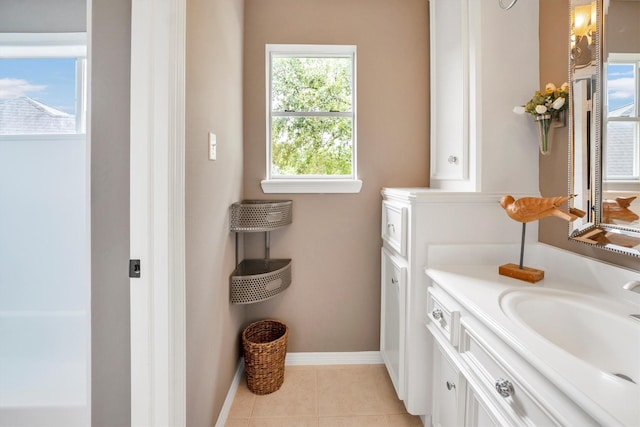 bathroom featuring baseboards, tile patterned floors, and vanity