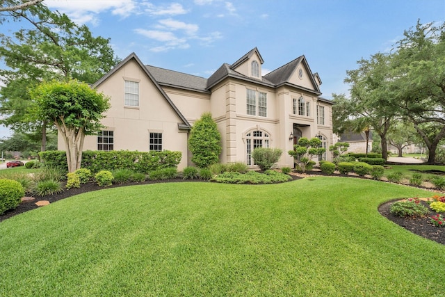 view of front of house featuring a front lawn and stucco siding
