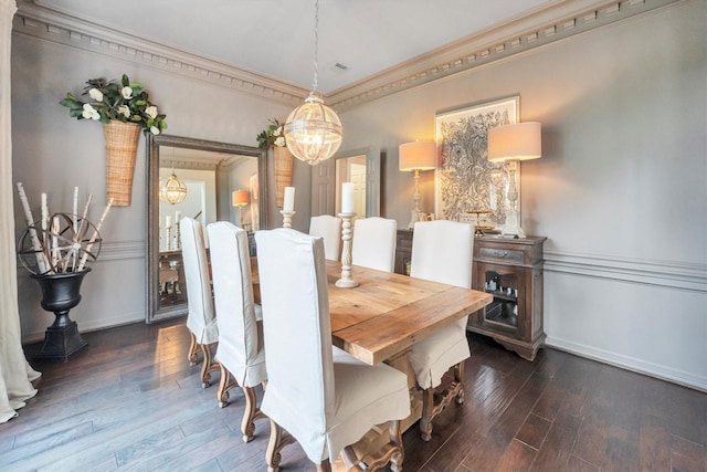 dining room with ornamental molding, an inviting chandelier, baseboards, and dark wood-type flooring