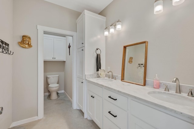 414 N Old Springfield Rd, North Zulch, TX 77872 - bathroom featuring baseboards, a sink, double vanity, and toilet