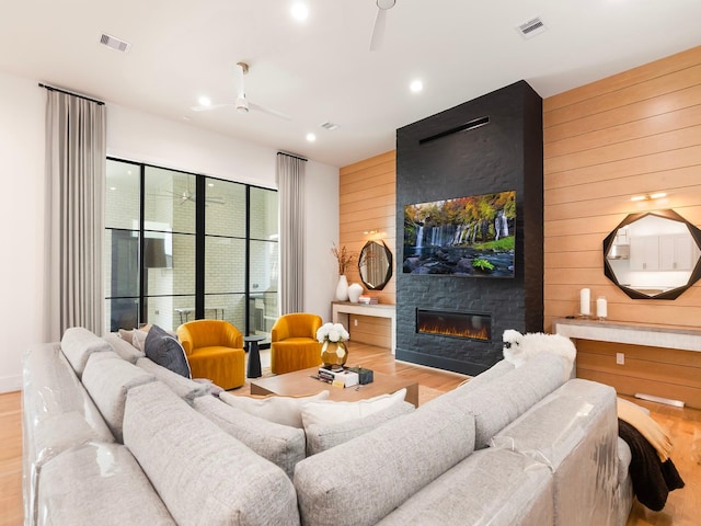 4024 Chatham, Houston, TX 77027 - living area with a ceiling fan, wood finished floors, wooden walls, a fireplace, and visible vents