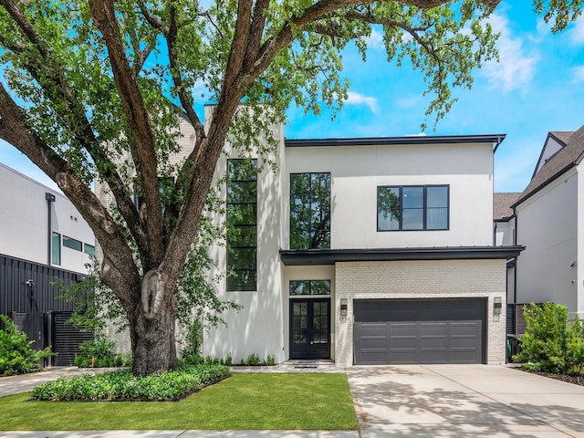 4024 Chatham, Houston, TX 77027 - contemporary home featuring stucco siding, concrete driveway, french doors, brick siding, and a garage
