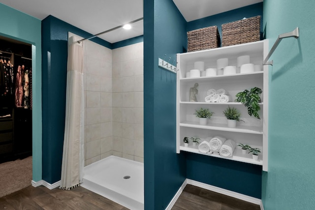 full bathroom with baseboards and tiled shower