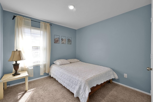 bedroom featuring baseboards and carpet flooring