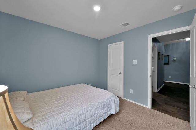 bedroom with baseboards, carpet flooring, and visible vents