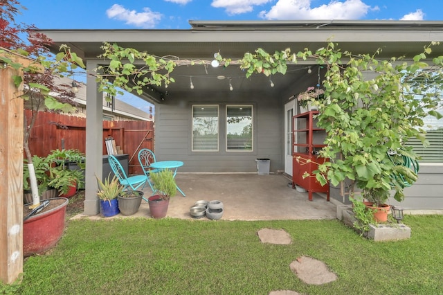 exterior space featuring a patio area, a lawn, and fence