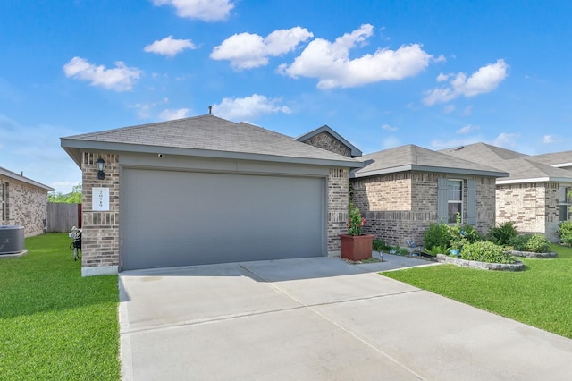 view of front facade with central AC unit, brick siding, a front yard, and concrete driveway