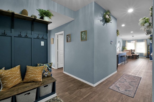 mudroom with baseboards, a sink, dark wood-style floors, and recessed lighting