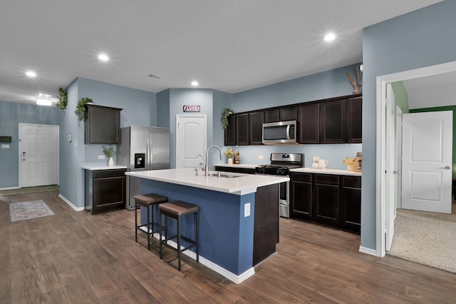 kitchen with recessed lighting, dark wood-style floors, light countertops, a sink, and appliances with stainless steel finishes