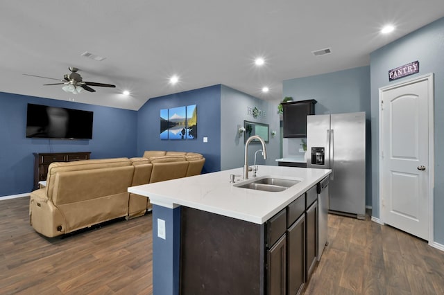 kitchen with visible vents, a sink, appliances with stainless steel finishes, and dark wood-style flooring