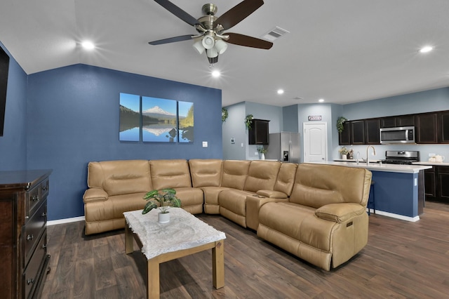 living room featuring dark wood-style flooring, a ceiling fan, visible vents, and recessed lighting