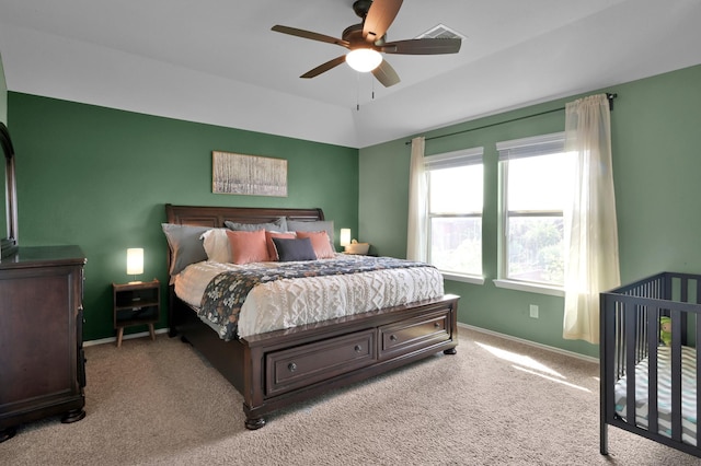 bedroom with carpet floors, visible vents, baseboards, and ceiling fan