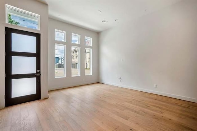 foyer featuring baseboards and light wood-style floors